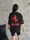 Woman in white Ferrari T-shirt with F1 sponsor patches