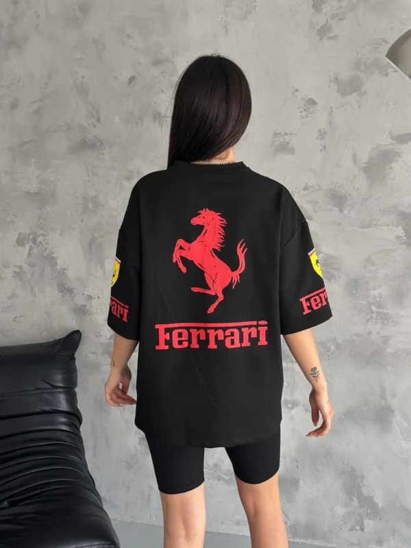 Woman in white Ferrari T-shirt with F1 sponsor patches